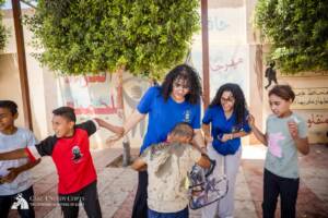 Volunteers and children playing water balloon games in Egypt
